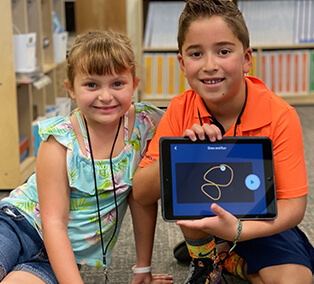 Girl and Boy Holding a Tablet