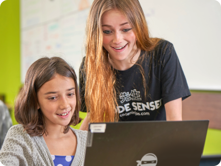 Happy sensei and happy girl using a laptop