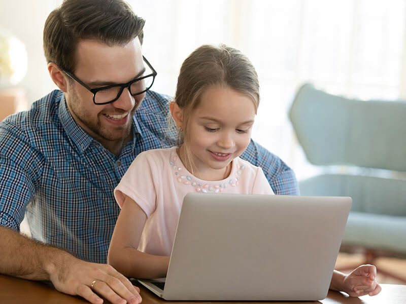 A man and a kid using a laptop