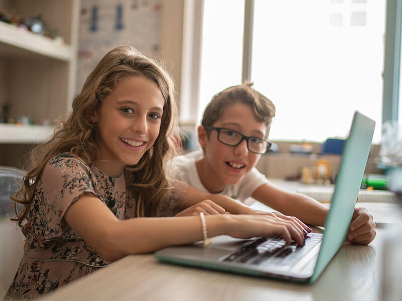 Boy and girl using a laptop